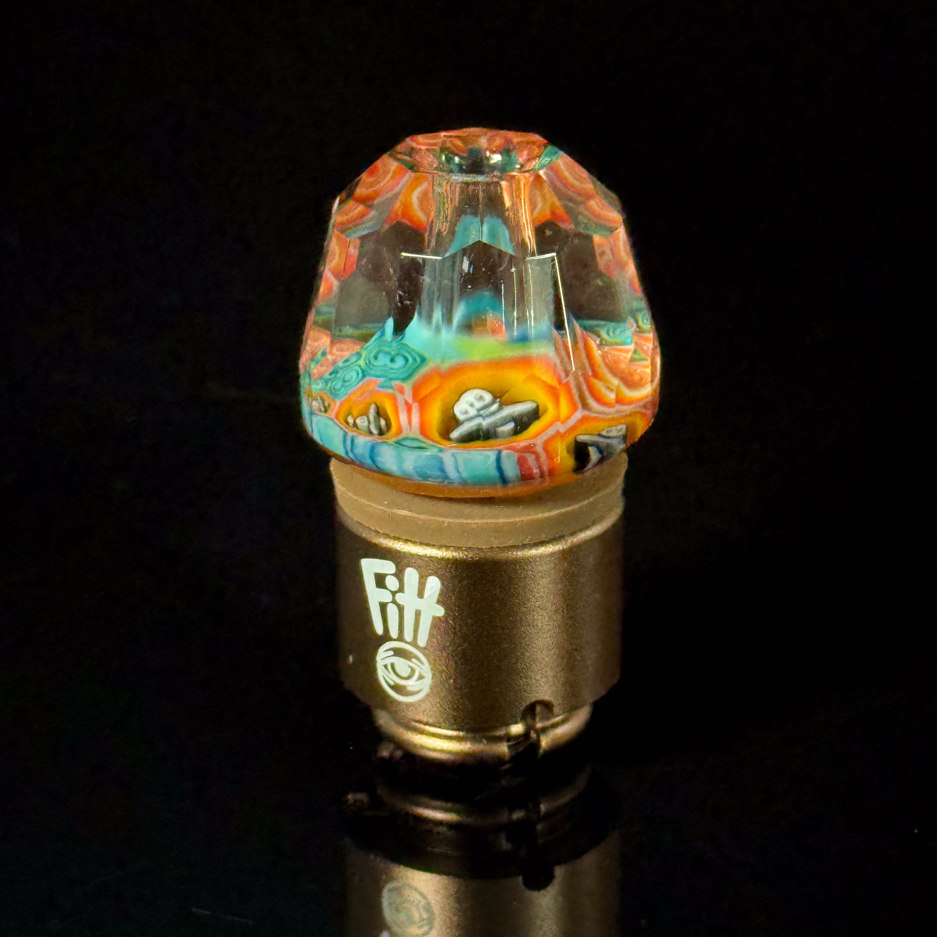 Colorful heady glass carb cap with intricate patterns, displayed on black background