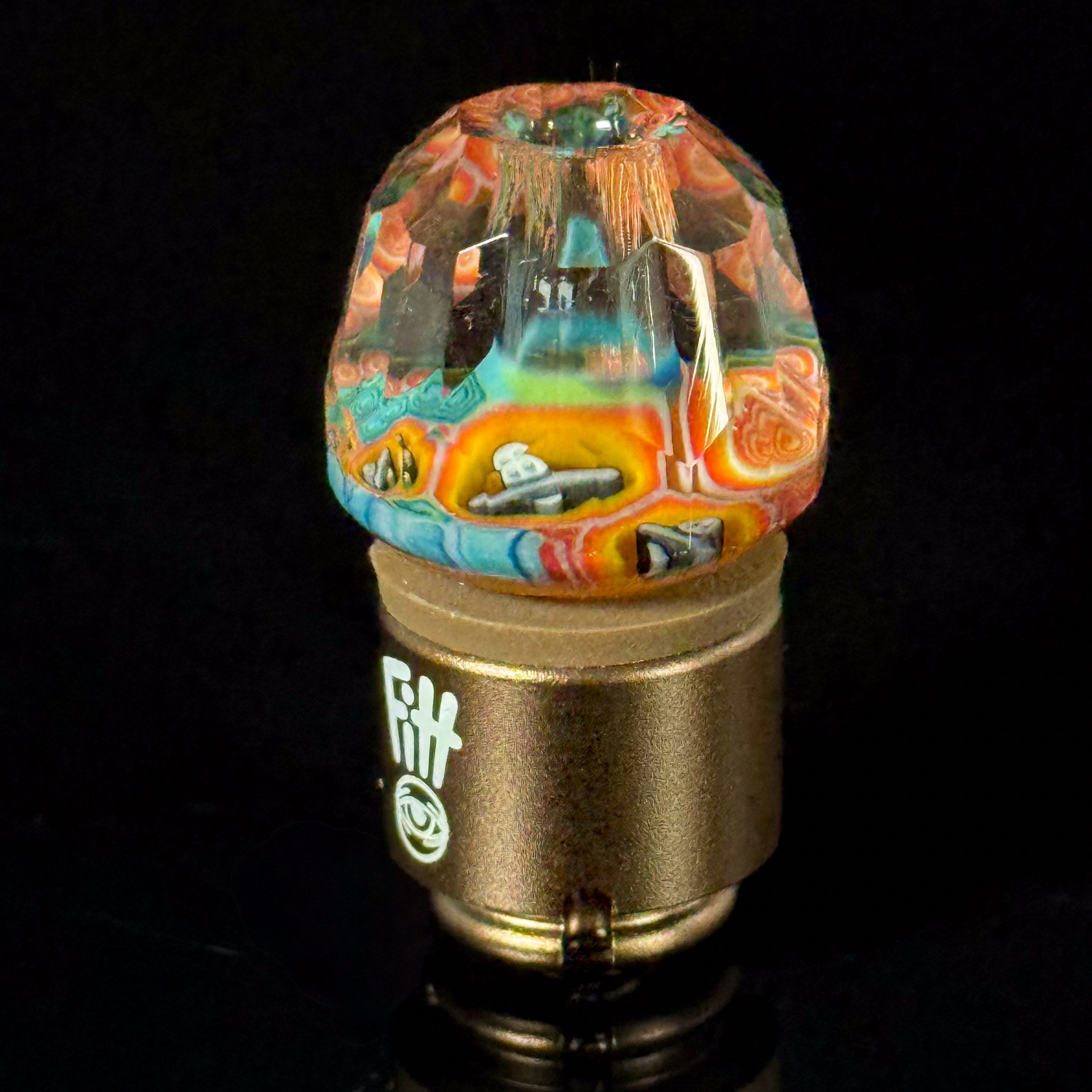 Colorful heady glass carb cap with intricate patterns for vaporizers on black background