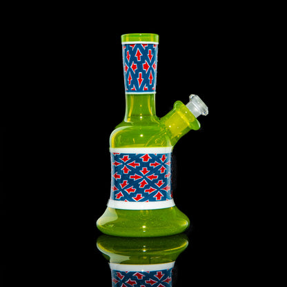 Green glass mini bong with blue, red, and white arrow pattern accents on a black background.
