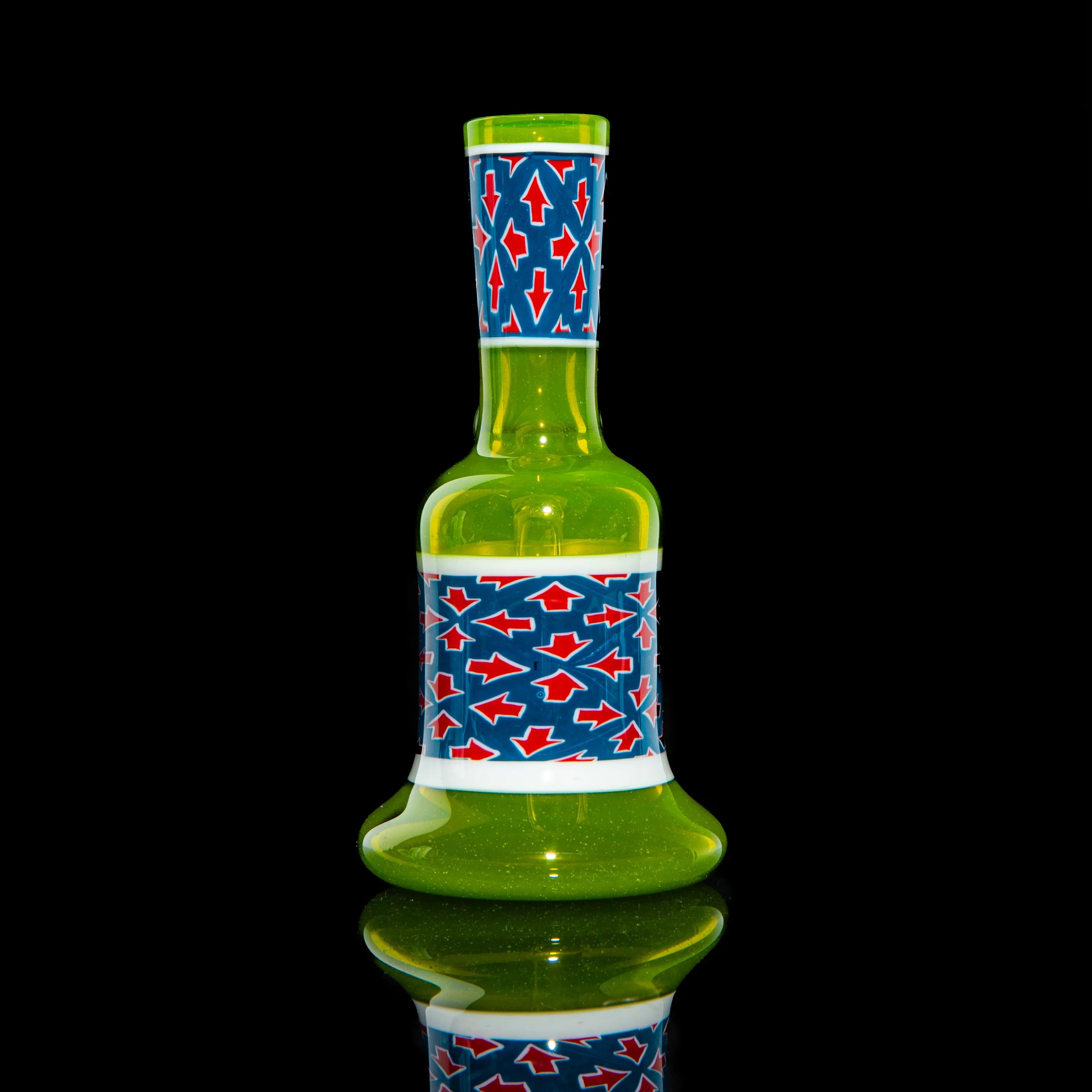 Green glass mini tube with blue and red arrow pattern on a black background