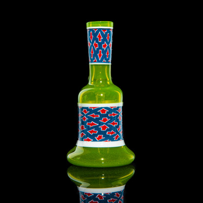 Green glass mini tube with blue and red arrow pattern on a black background