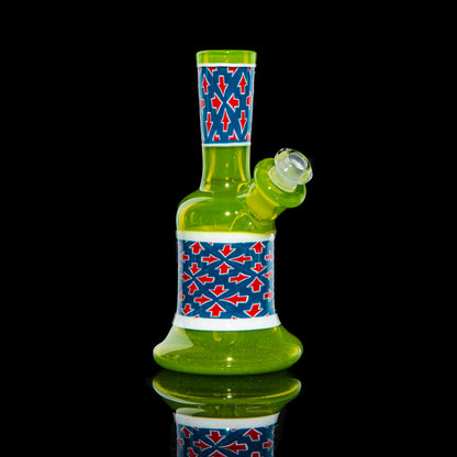 Green mini glass water pipe with red and blue geometric pattern on black background