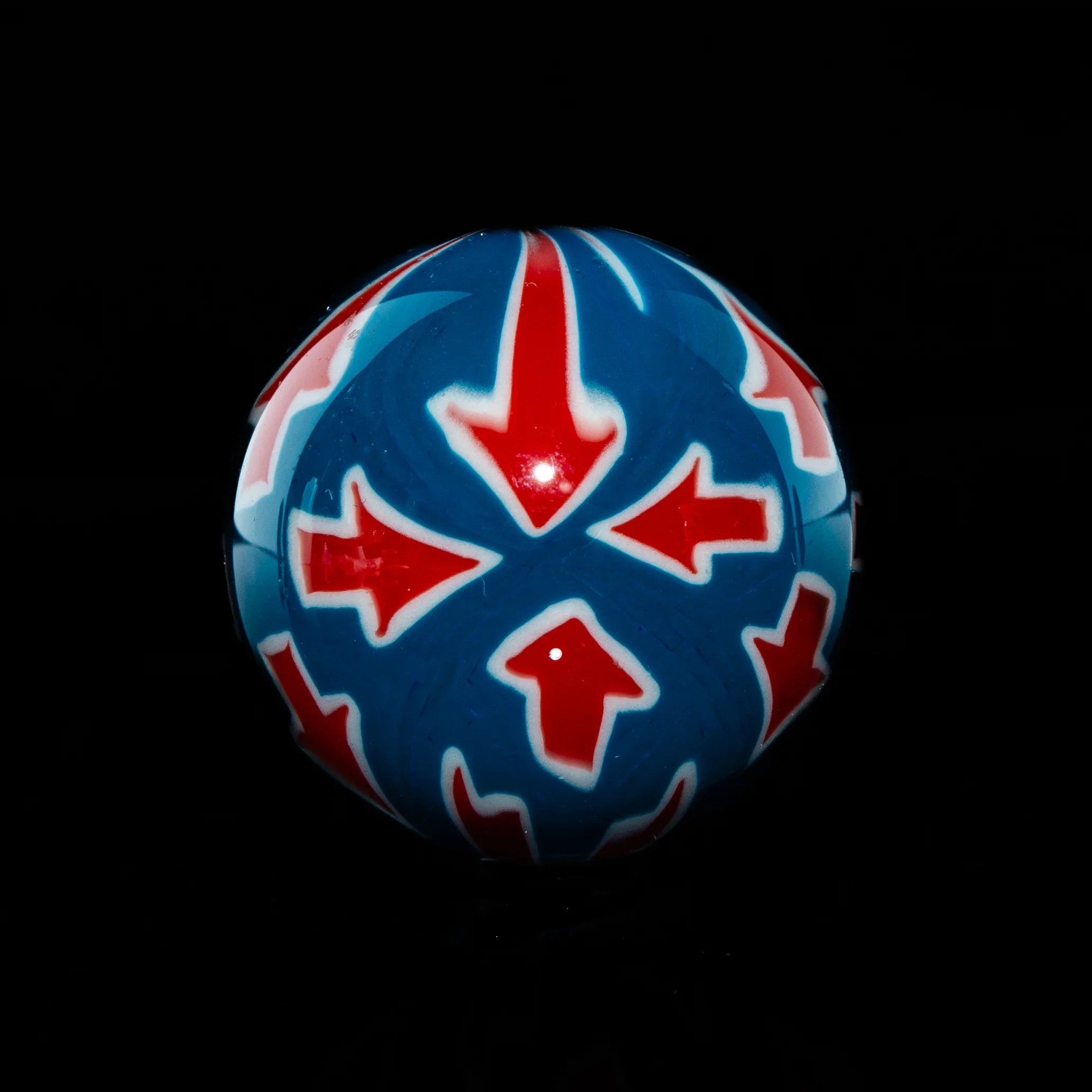 Colorful glass marble with red arrows and blue background for smoking accessories