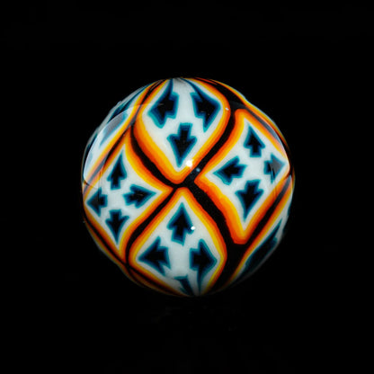 Colorful glass marble with geometric blue, orange, and white patterns on a black background
