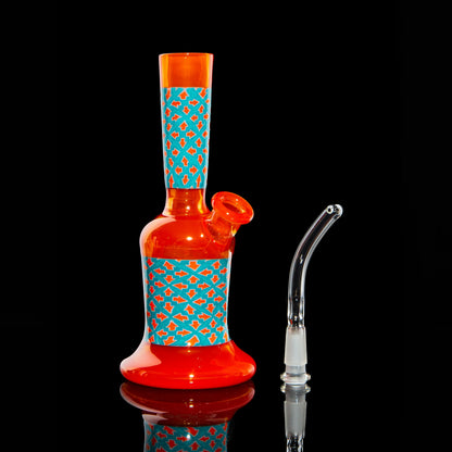 Colorful orange glass water pipe with blue geometric accents and separate clear glass downstem.