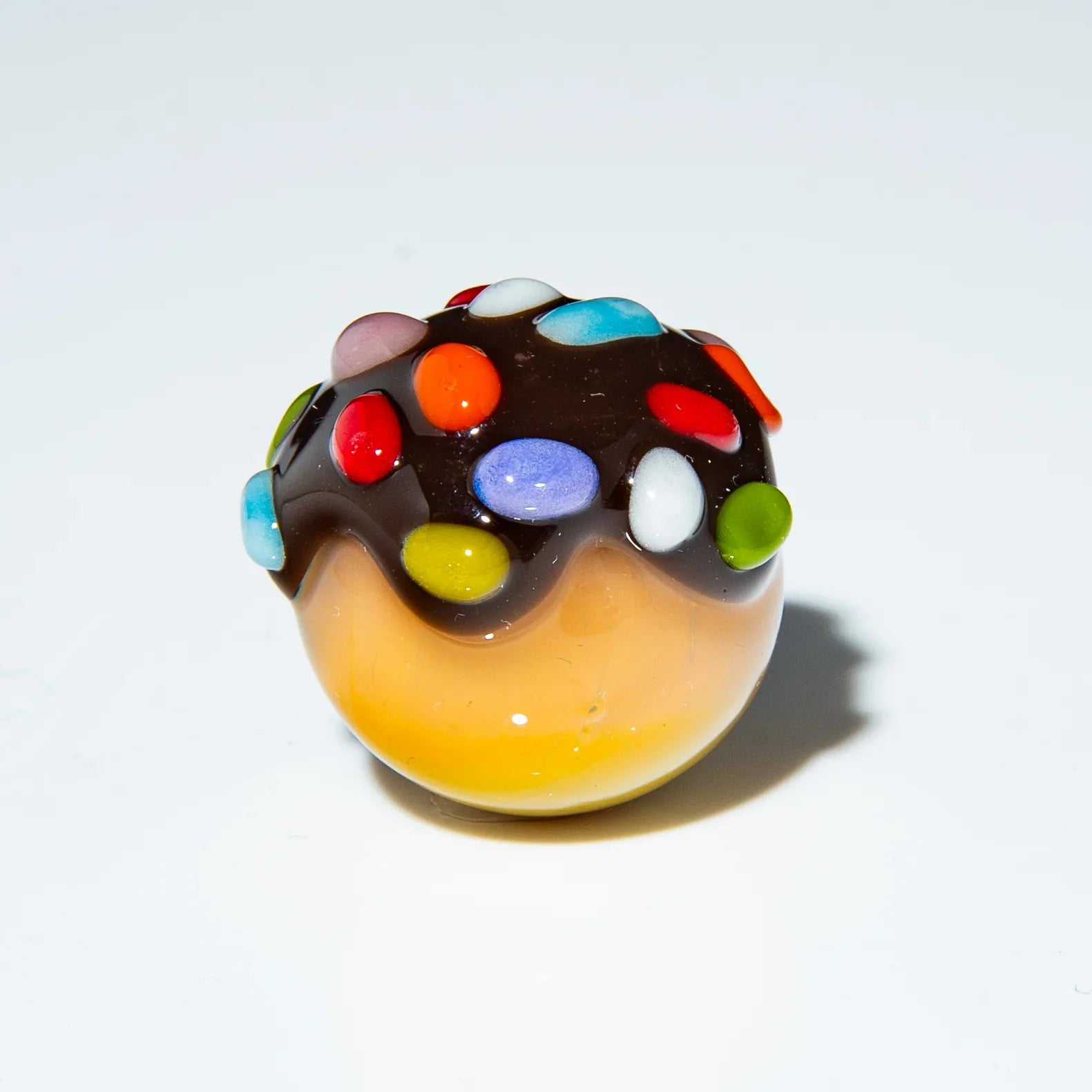 Handcrafted glass marble with chocolate top and colorful rainbow sprinkles design