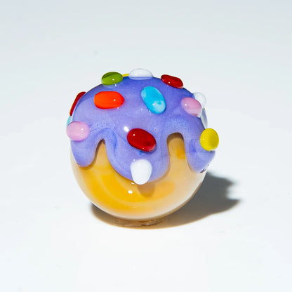 Hand-blown glass marble with lavender top and colorful rainbow sprinkles accents