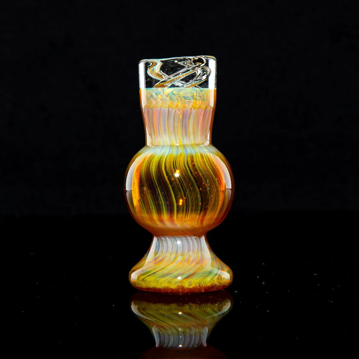 Amber and purple glass spinner bubble cap with swirled design on black background