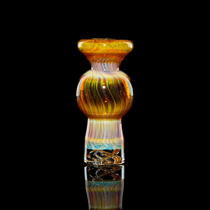 Amber purple spinner bubble cap with swirling glass pattern on a black background