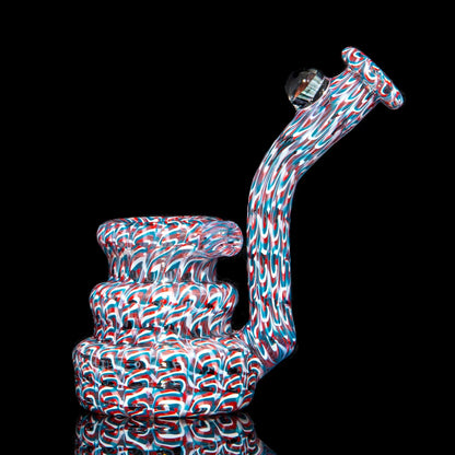 Colorful heady glass water pipe with intricate red, white, and blue swirl patterns
