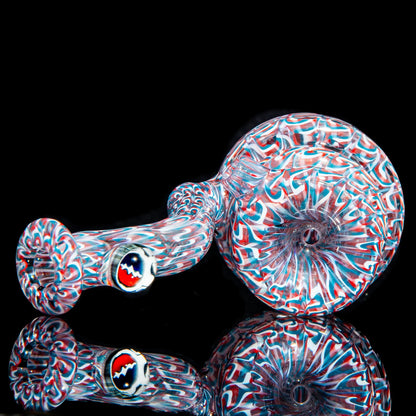 Colorful hand-blown glass pipe with red, white, and blue swirl patterns on black background