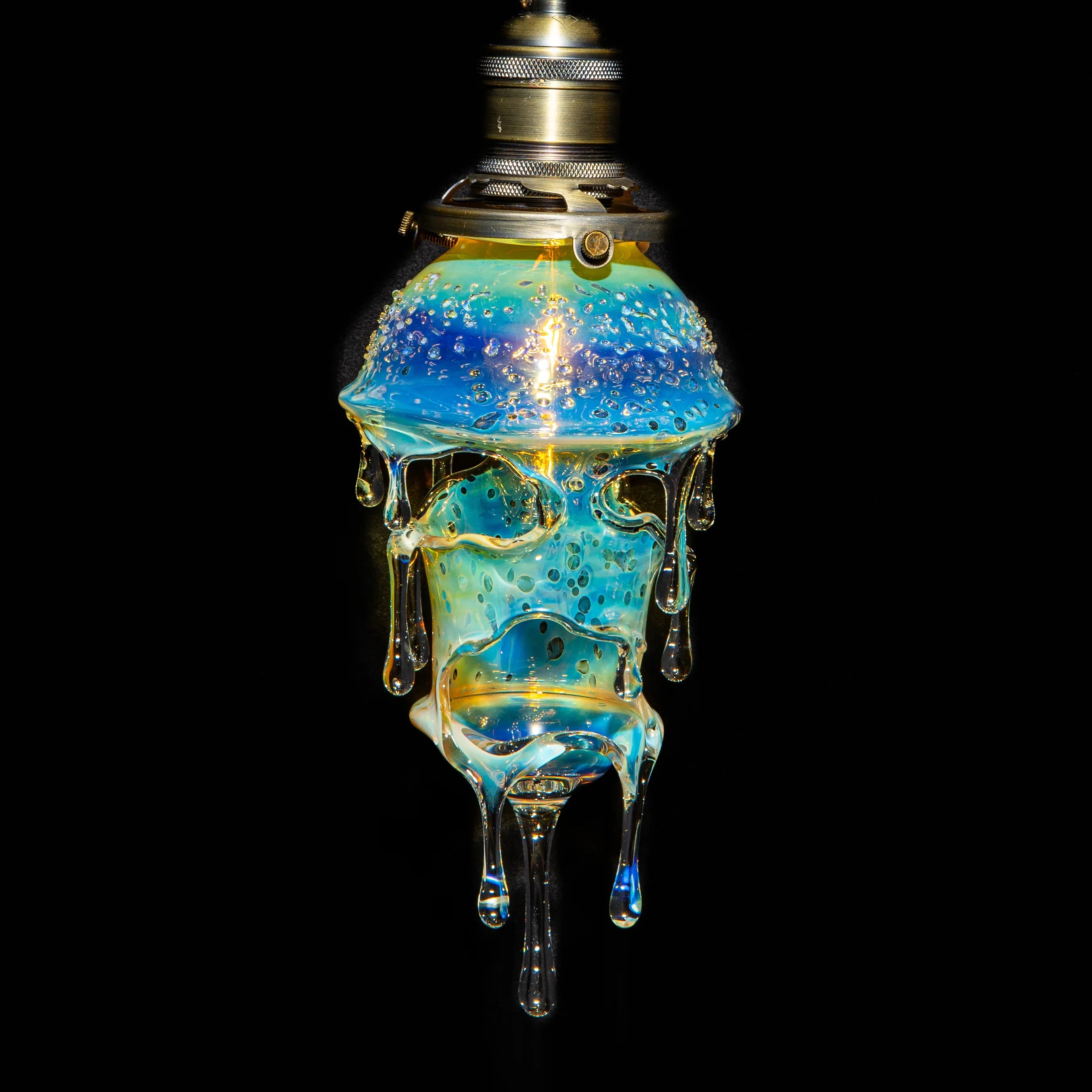 Hand-blown glass lamp with dripped, bubble-filled design and iridescent blue hues