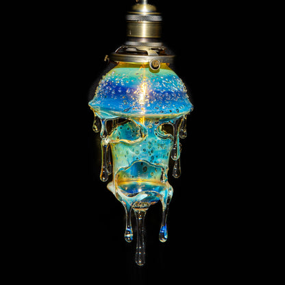 Hand-blown glass lamp with dripped, bubble-filled design and iridescent blue hues