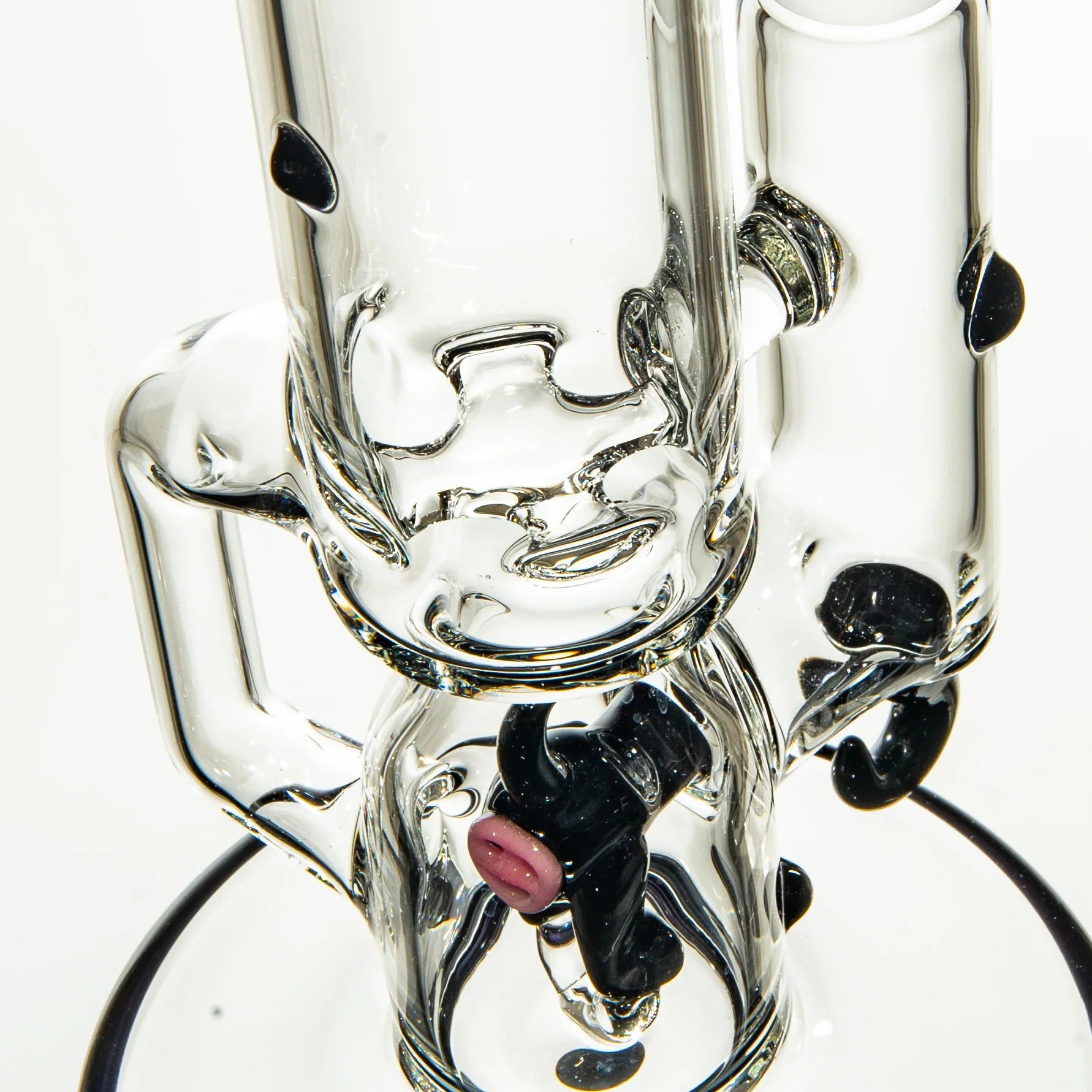 Close-up of a clear glass water pipe with black accents and artistic glasswork details