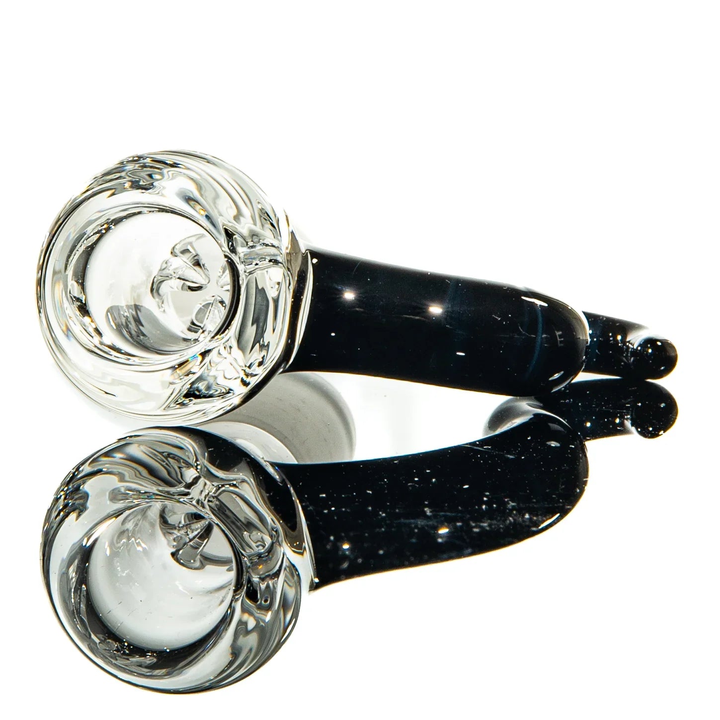 Clear and black glass hand pipe with rounded bowl on white reflective surface
