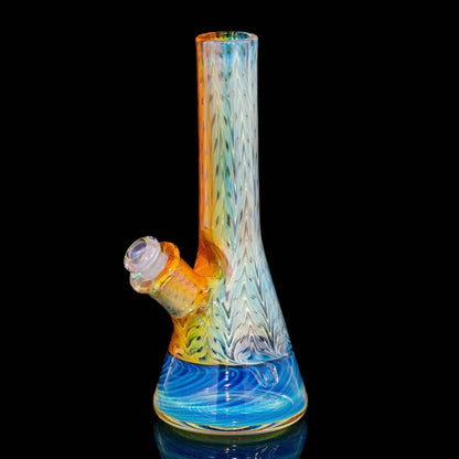 Colorful glass water pipe with blue spiral base and chevron pattern on a black background