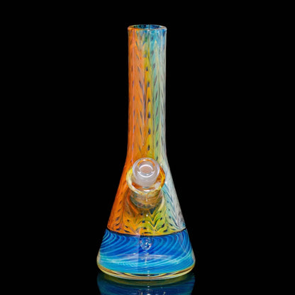Colorful glass beaker bong with orange, yellow, and blue swirl pattern on black background