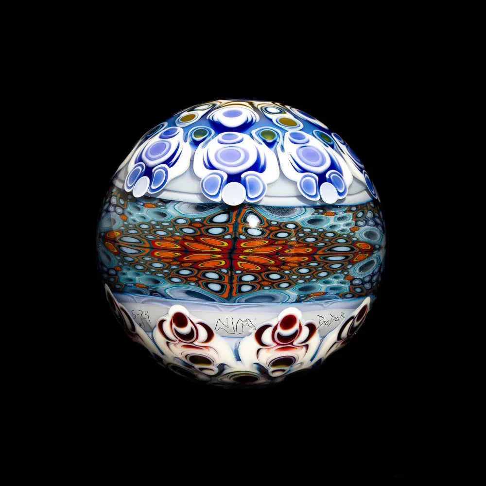 Colorful glass art orb with intricate patterns and vibrant blue, red, and white designs