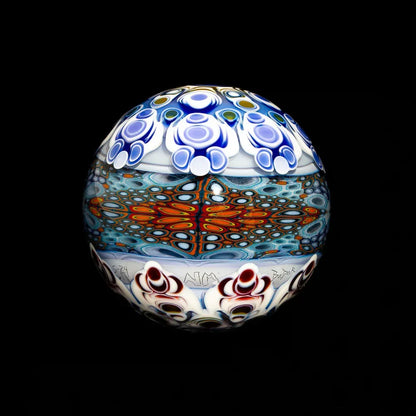 Colorful glass art orb with intricate patterns and vibrant blue, red, and white designs