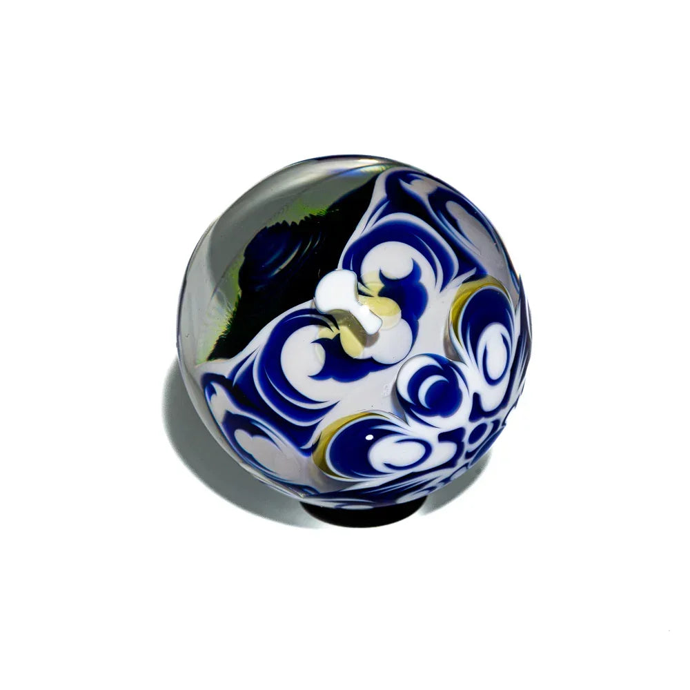 Art glass orb with blue, white, and gold swirl patterns on a white background