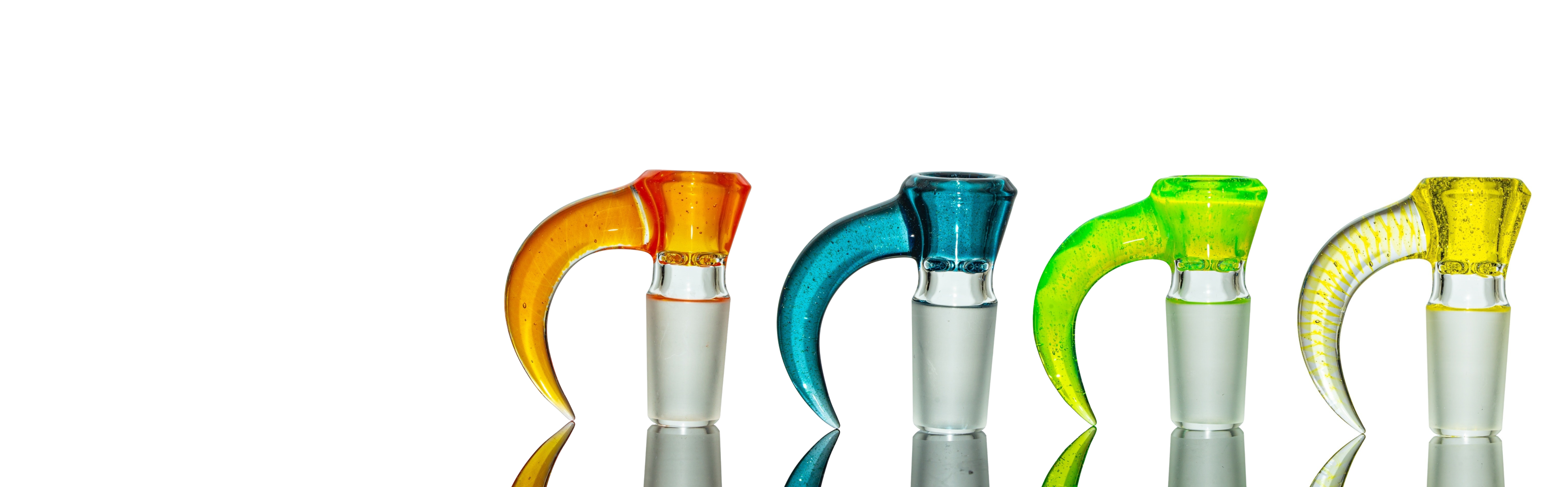 Four glass smoking accessories with colorful handles on a white background