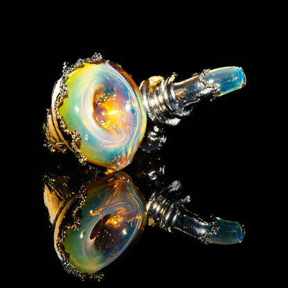 Colorful Sherlock glass pipe with gold and metallic accents on a reflective black surface.