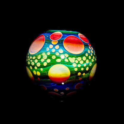 Colorful heady glass marble with vibrant swirling patterns and dot accents on black background