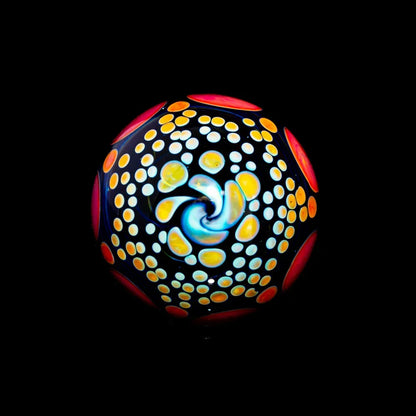 Colorful heady glass marble with swirl and dot pattern on black background