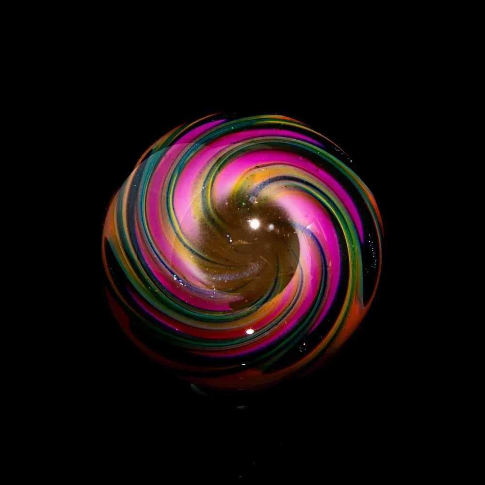 Hand-blown glass marble with vibrant rainbow swirl design on black background