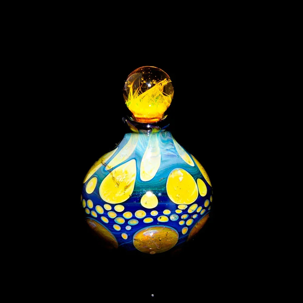 Heady glass jar with blue and yellow accents and a decorative marble lid