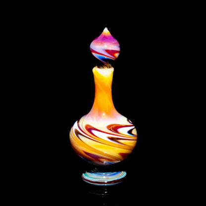 Colorful hand-blown glass art bottle with swirling patterns on a black background