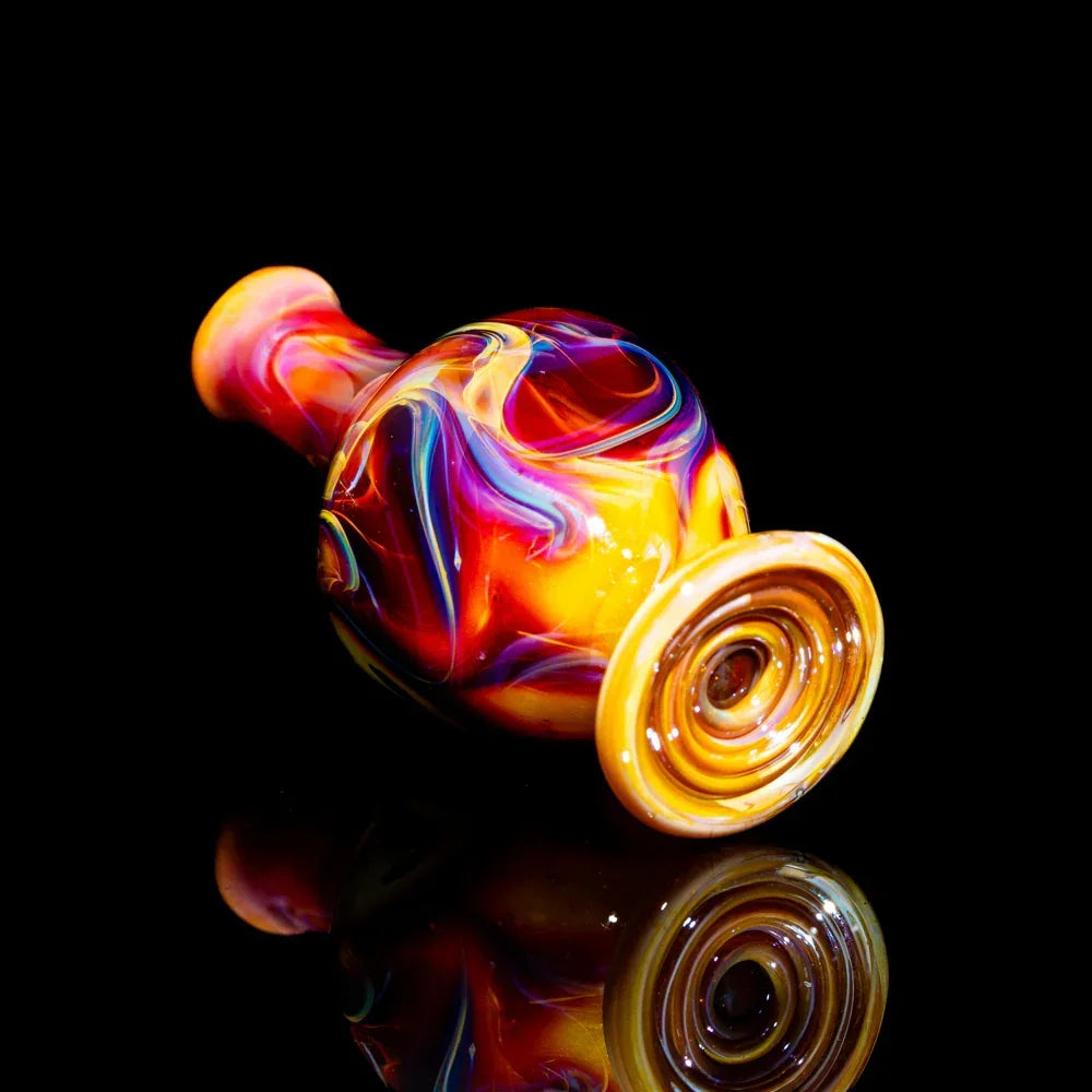 Colorful hand-blown glass pipe with vibrant swirls on black background
