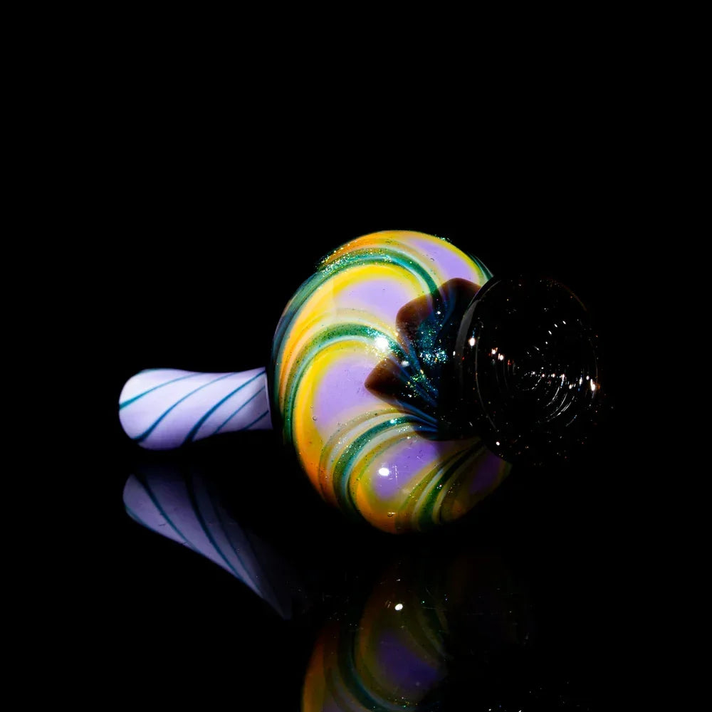 Colorful hand-blown glass pipe with swirling yellow, green, and purple patterns