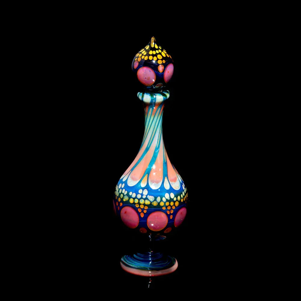 Colorful heady glass bottle with intricate patterns and vibrant dots on black background