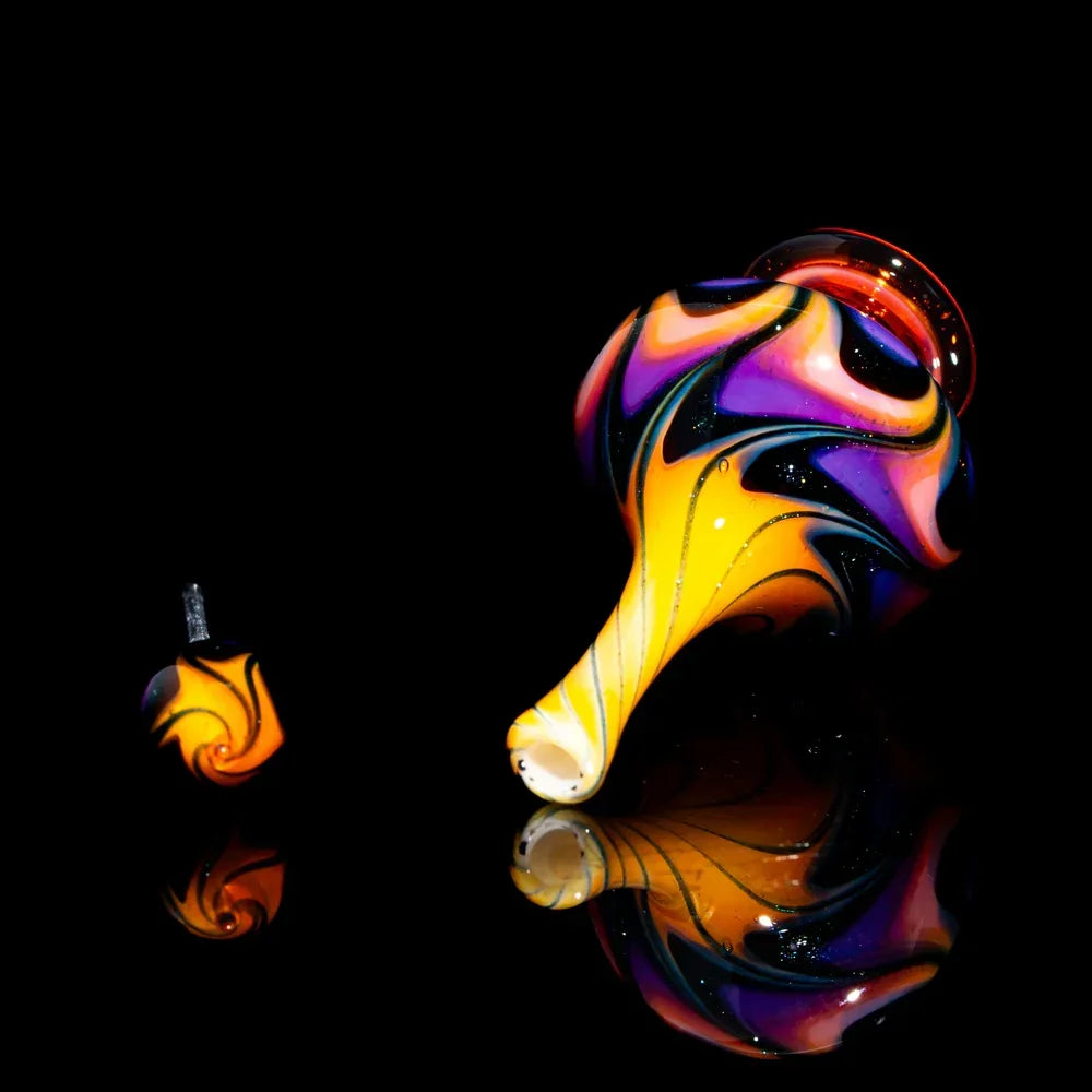 Colorful heady glass pipe and carb cap set with vibrant swirl design on black background