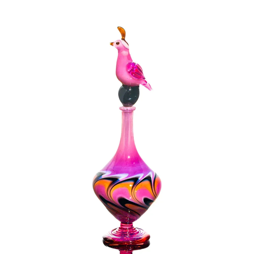 Colorful glass art piece with a pink bird topper and swirling pink, orange, and black design