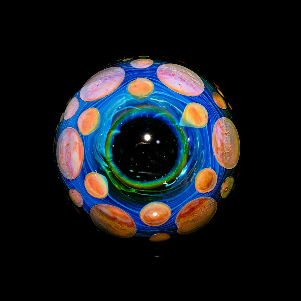 Handcrafted glass marble with vibrant blue, orange, and green swirling designs