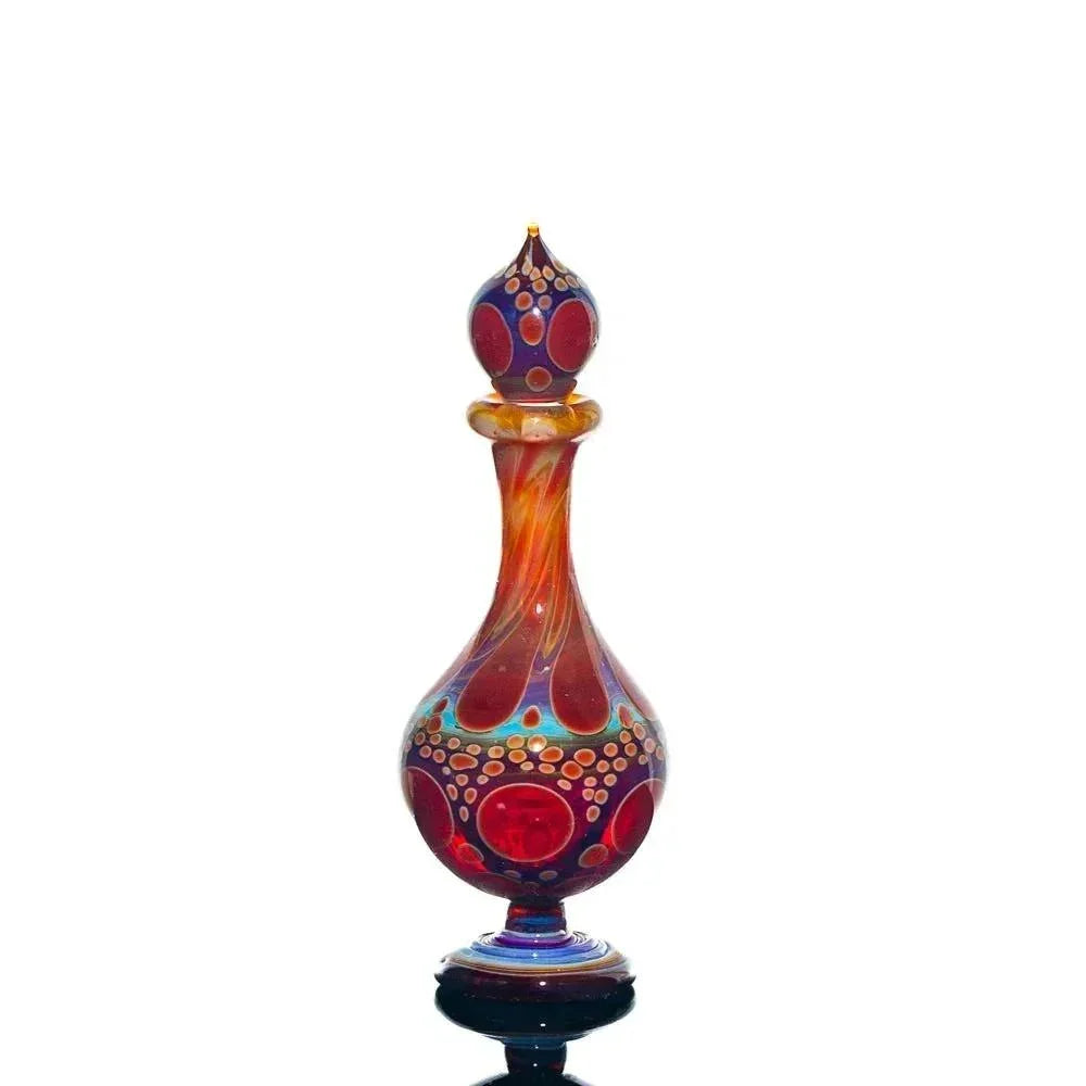 Colorful hand-blown glass perfume jar with red, blue, and orange swirl patterns