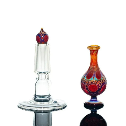 Handblown glass perfume jar with vibrant red and orange patterns, decorative stopper