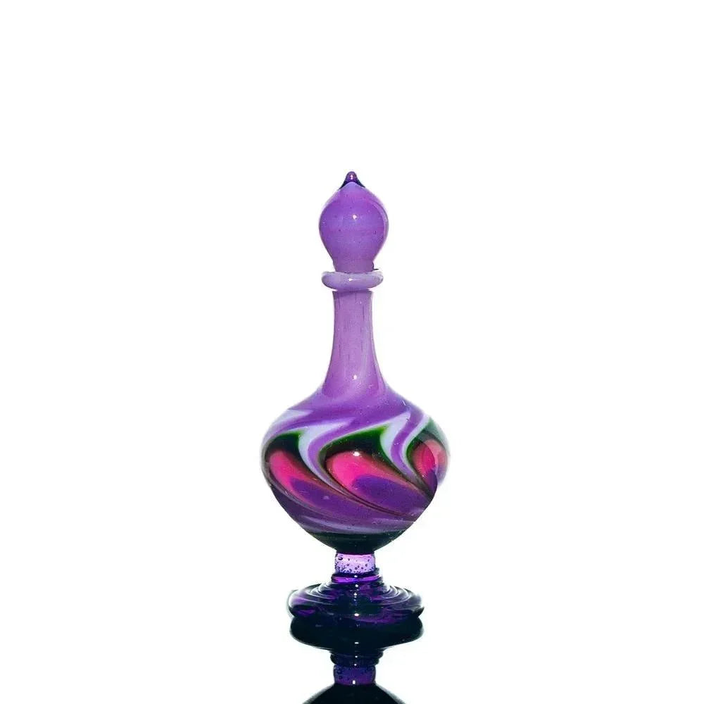 Handblown purple glass perfume jar with pink, green, and white swirl accents on white background