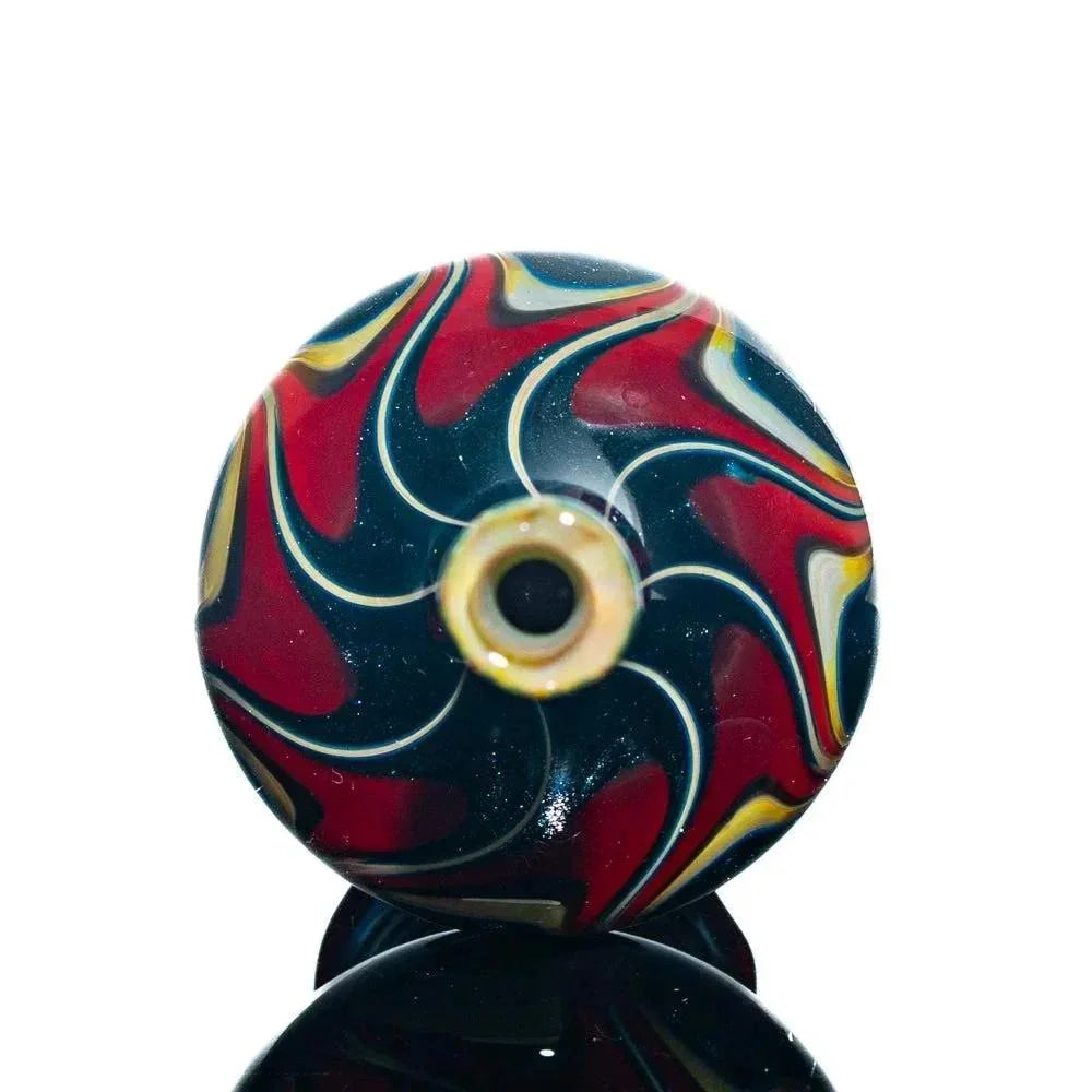 Hand-blown glass jar with red, yellow, and black swirl pattern, circular top view
