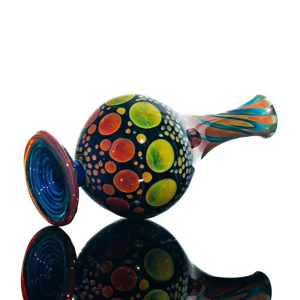 Colorful hand-blown glass jar with vibrant dot patterns and a striped neck