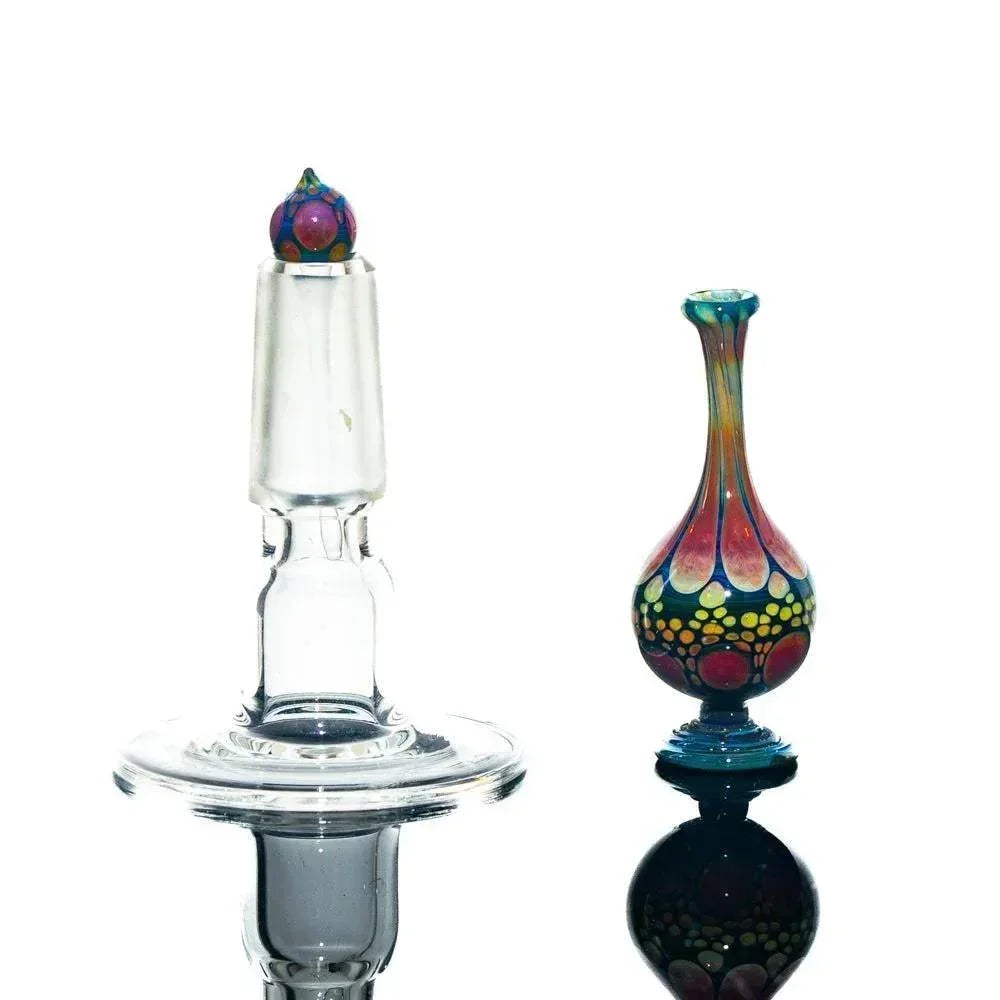 Handcrafted glass perfume jar and stopper with colorful, detailed patterns on white background.
