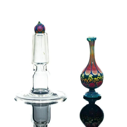 Handcrafted glass perfume jar and stopper with colorful, detailed patterns on white background.