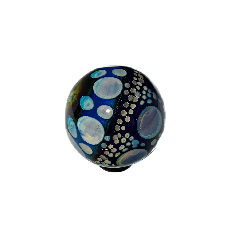Handcrafted glass marble with blue hues and iridescent bubble patterns on a white background