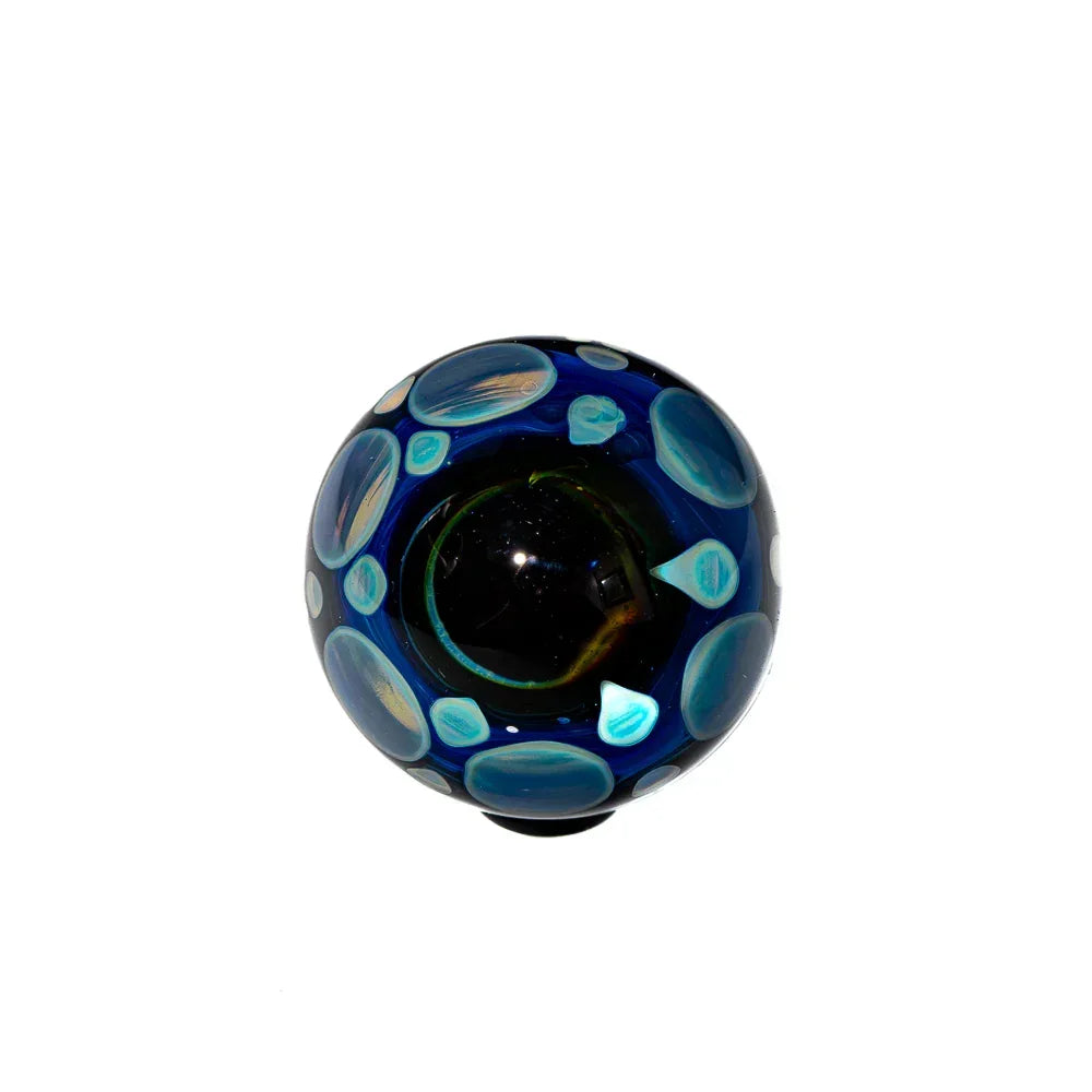 Handmade glass marble with blue and aqua swirl patterns on a white background