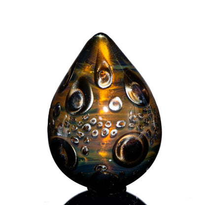 Handcrafted bronze glass egg with raised dragon scale patterns for glass art collectors.