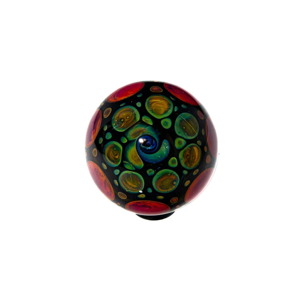 Handcrafted heady glass marble with vibrant swirling colors and intricate dot patterns