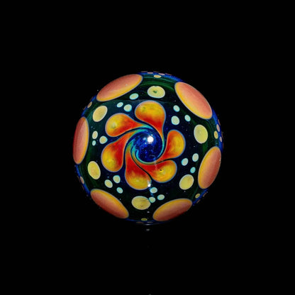 Handcrafted glass marble with blue, green, red, and yellow swirl hobnail design