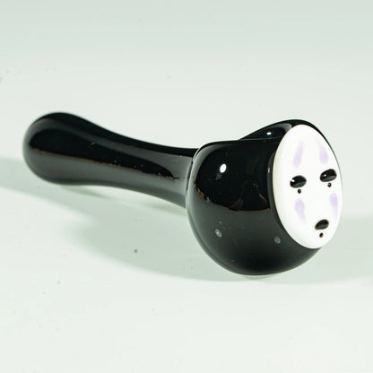 Black glass hand pipe with stylized white face design, heady glass smoking accessory